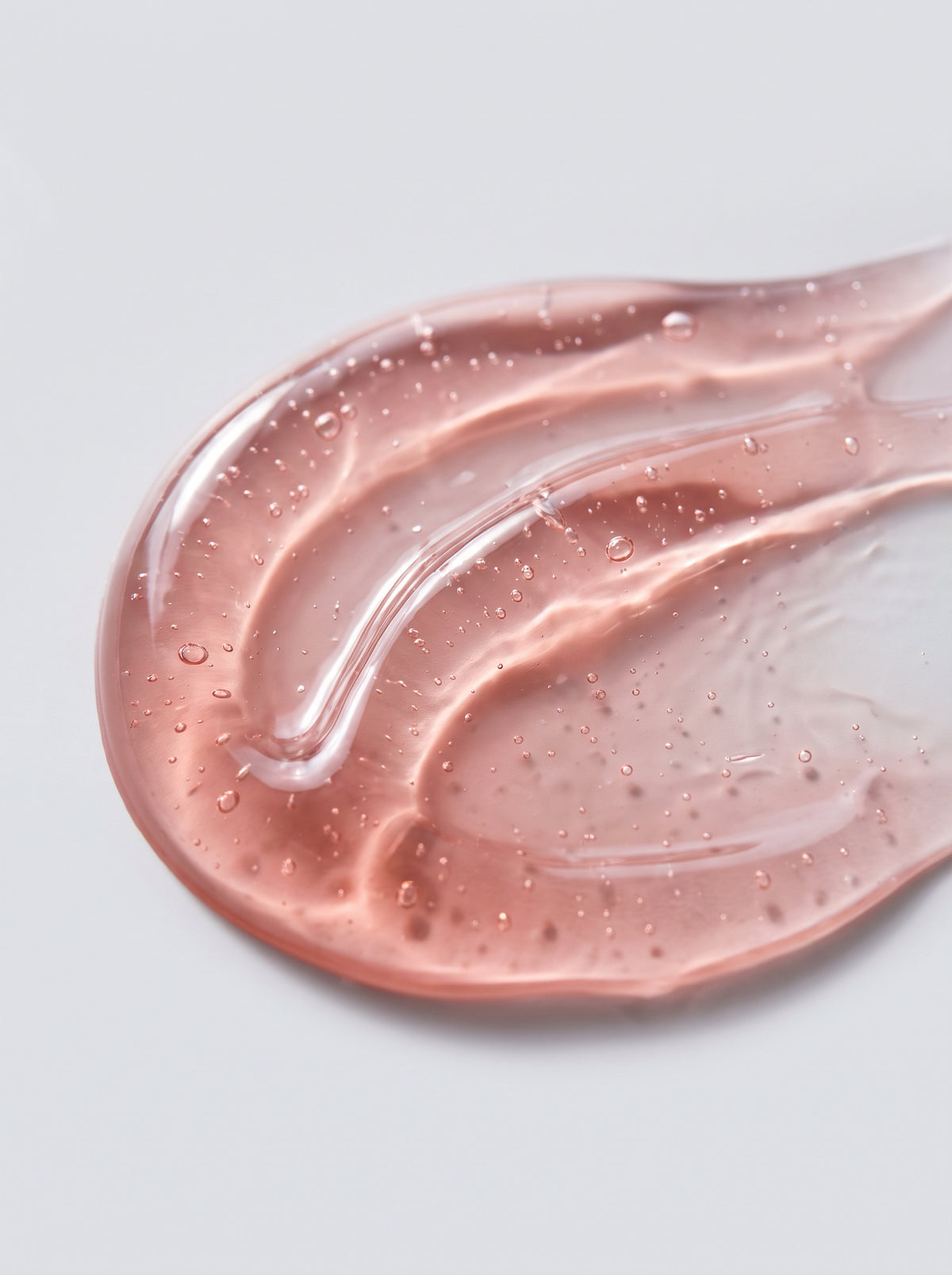 SILNT Radiance Cleanser pink jelly gel swatch with bubbles on a light grey background