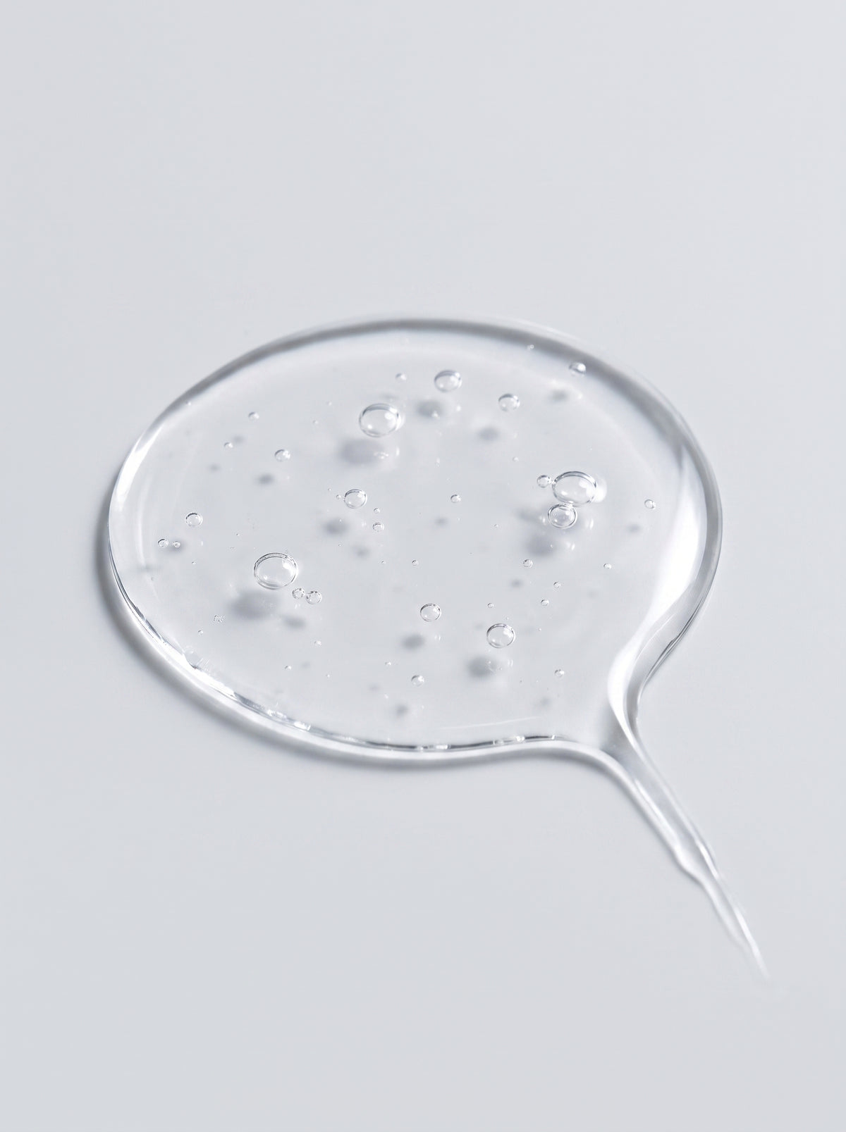 Clear gel droplet of SILNT Caffeine Booster showing tiny bubbles and its transparent texture