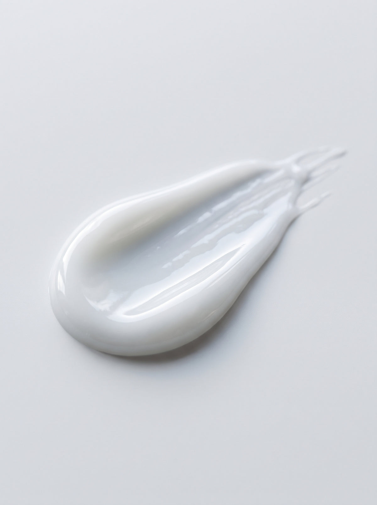 SILNT Plumping Serum milky white swatch with a glossy finish on a light grey background