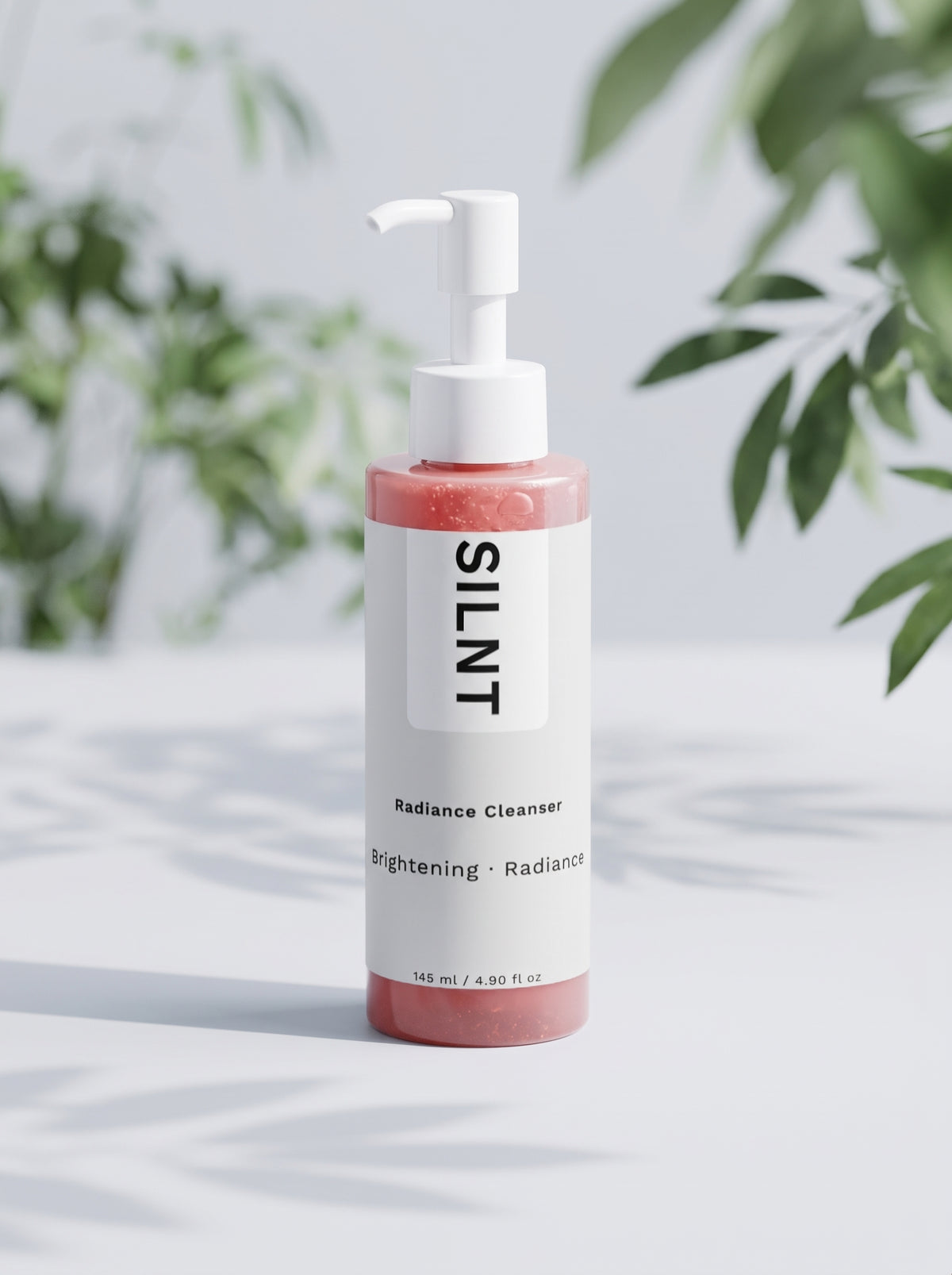 SILNT Radiance Cleanser bottle beside its carton with soft leaf shadows on a light grey background