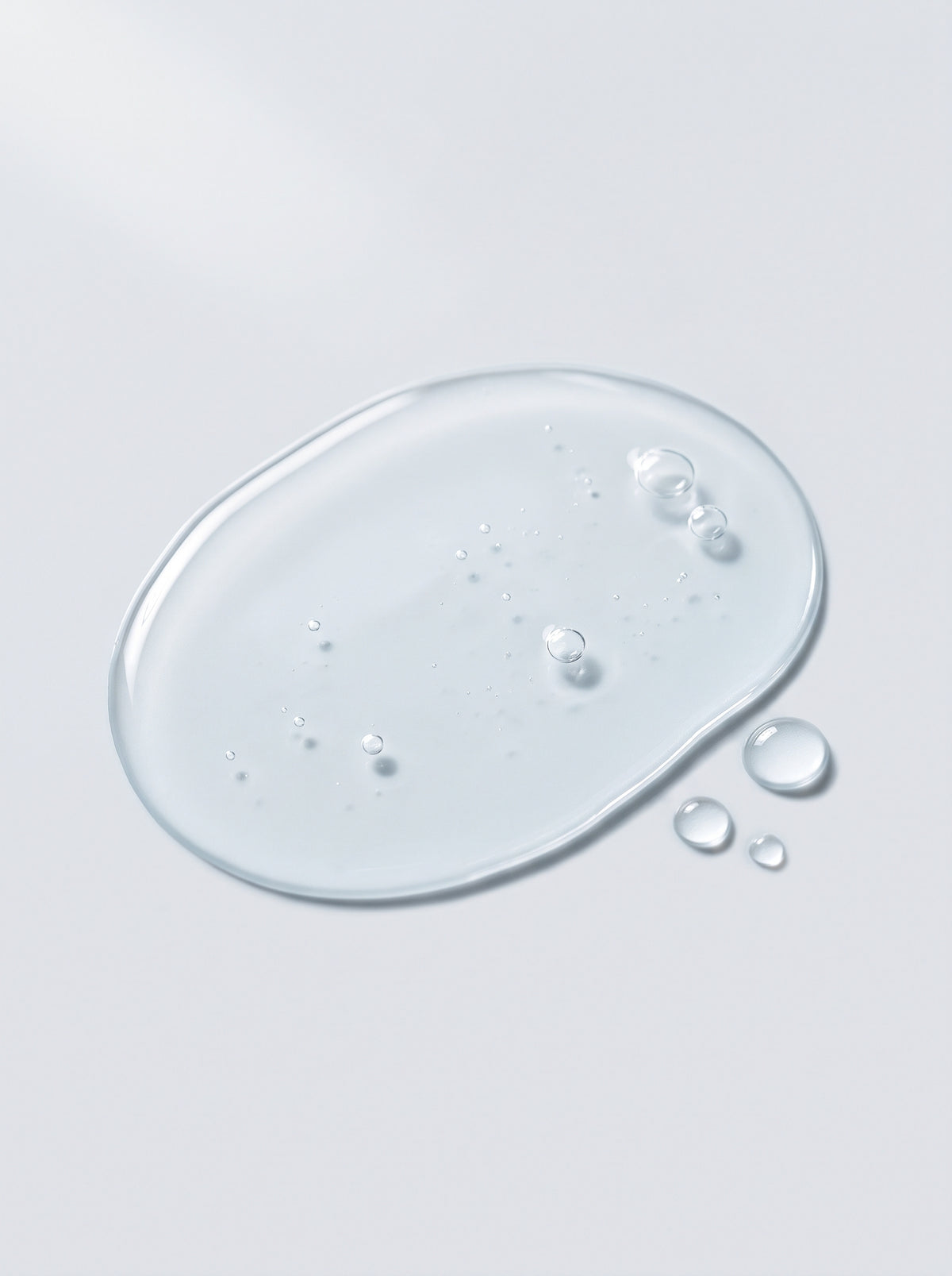 Clear liquid toner droplet of SILNT Glycolic Toner showing its transparent texture and small bubbles