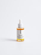 SILNT Facial Oil glass dropper bottle with amber oil on a light grey background