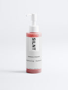 SILNT Radiance Cleanser clear pump bottle with pink gel on a light grey background
