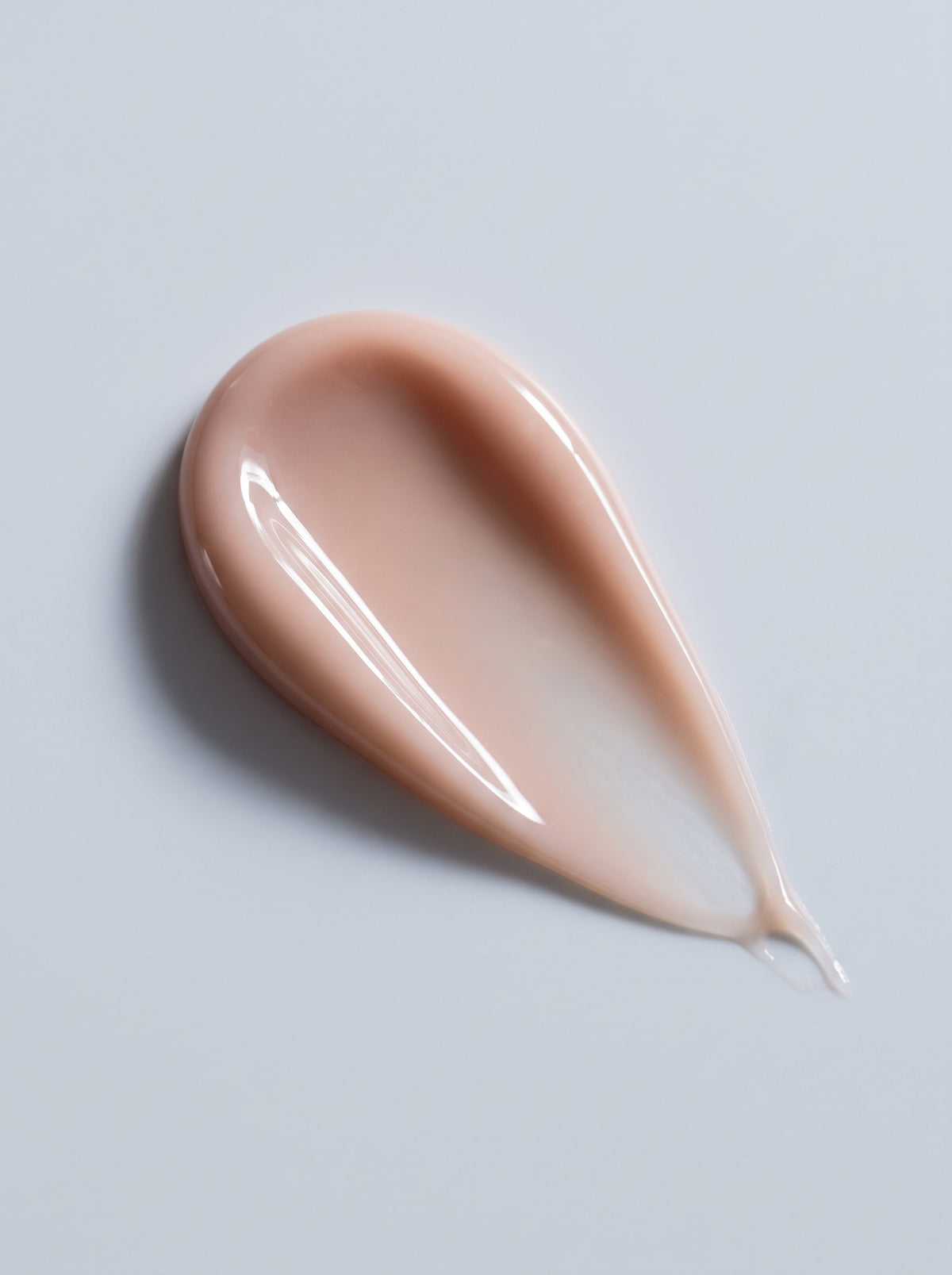 SILNT Hydrating Serum nude-pink swatch with a glossy dewy finish on a light grey background