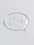 Clear gel droplet of SILNT Caffeine Booster showing tiny bubbles and its transparent texture