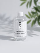 SILNT Glycolic Toner bottle beside a leafy plant casting soft shadows