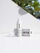 SILNT Vitamin C Serum bottle in natural light with soft plant shadows