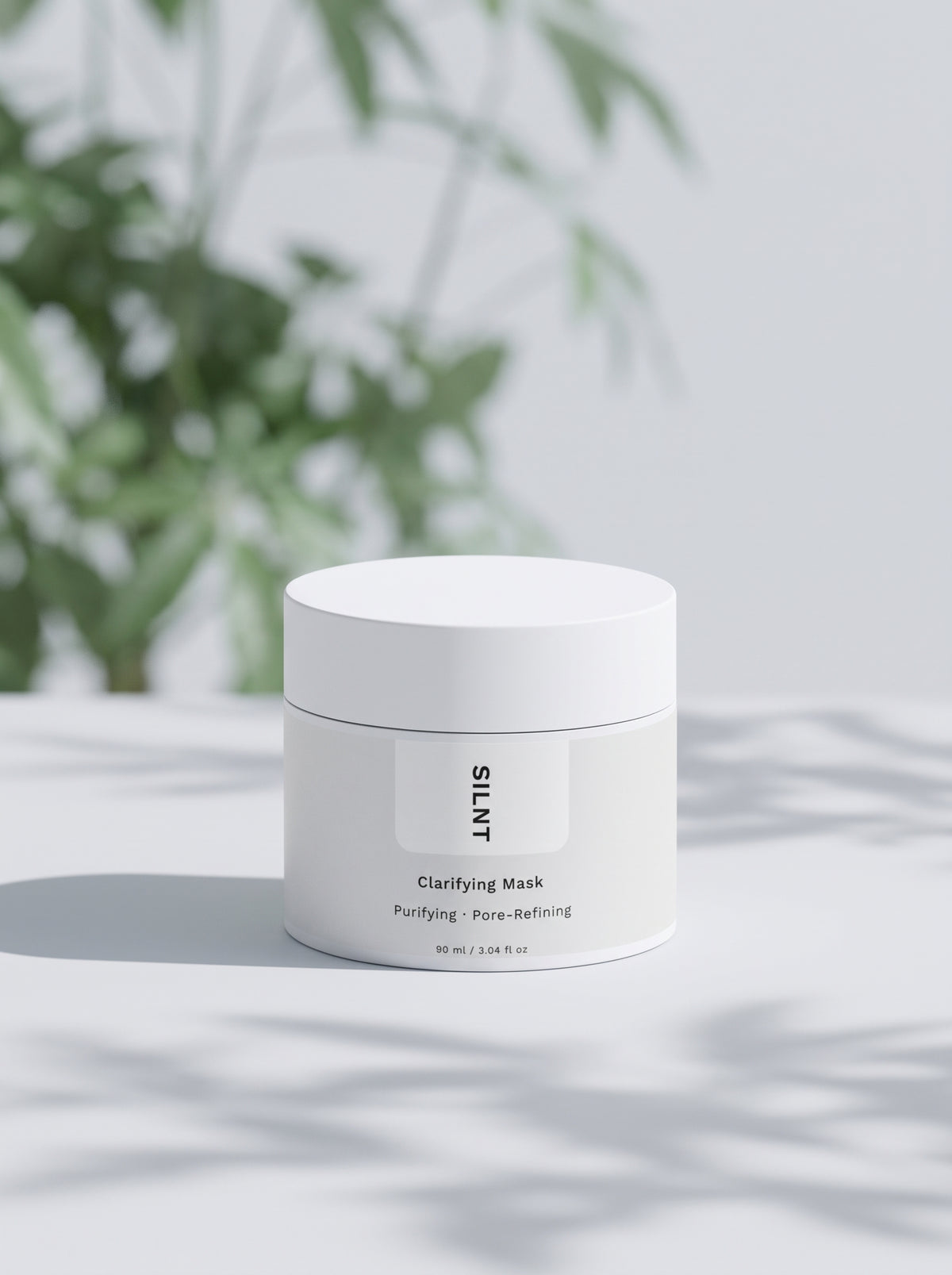 SILNT Clarifying Mask jar beside soft leaf shadows on a light grey background