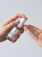 Hand dispensing SILNT Caffeine Booster from the pump onto an open palm