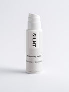 SILNT Brightening Polish airless pump bottle on a light minimalist background