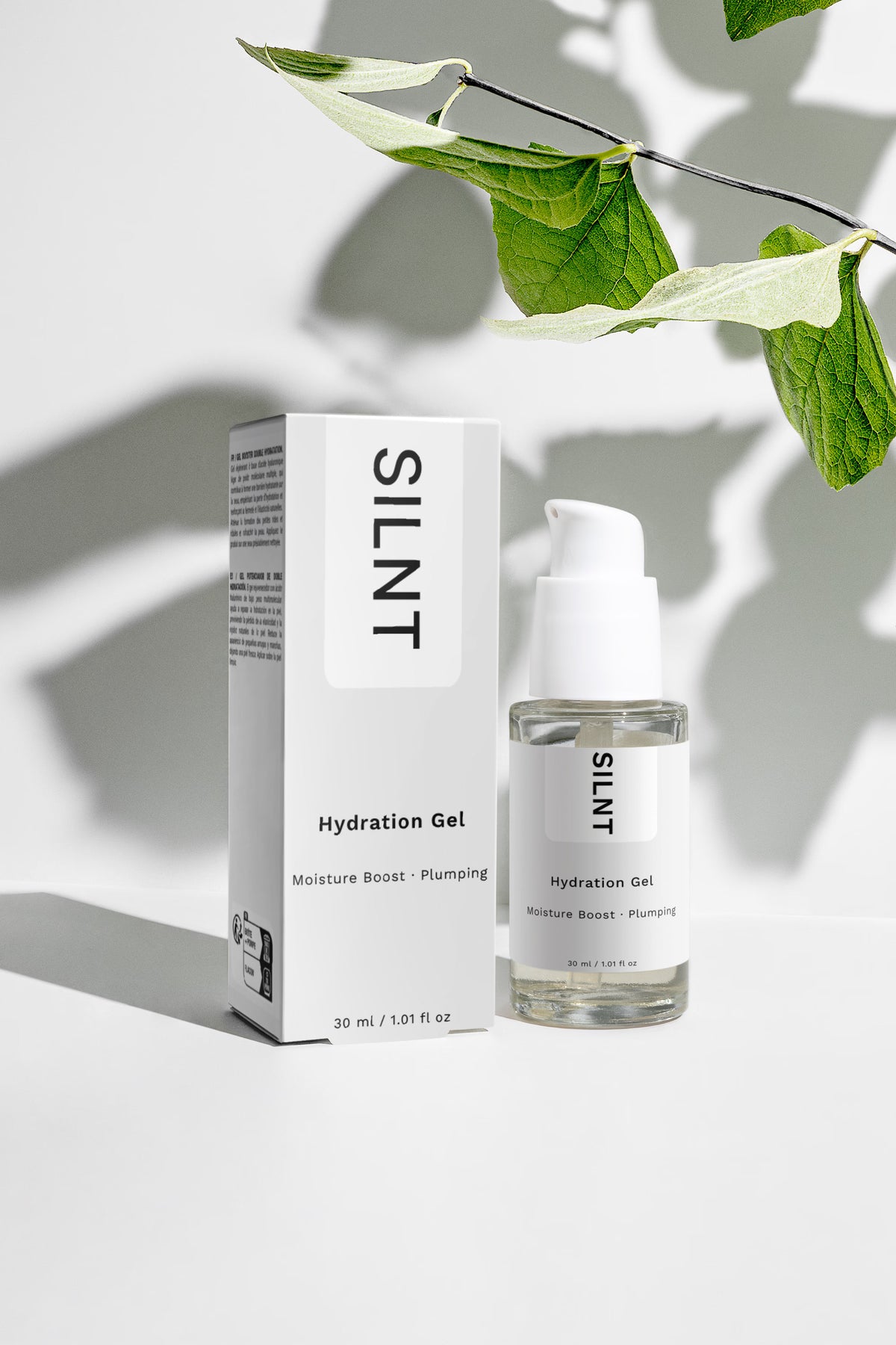 SILNT Hydration Gel bottle beside its carton with soft leaf shadows on a light grey background